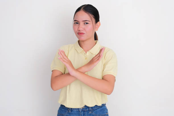 istock A woman doing stop hand gesture with worried expression 2181641257