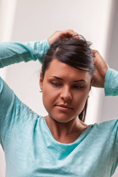 istock Woman tying her hair in a ponytail getting ready for workout 2181646508