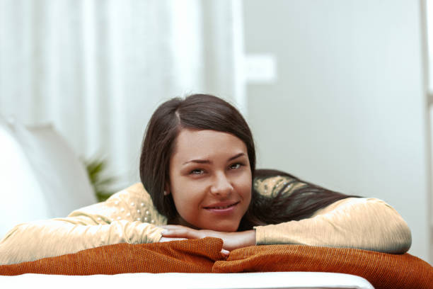 Serene woman relaxing at home, embracing comfort and control