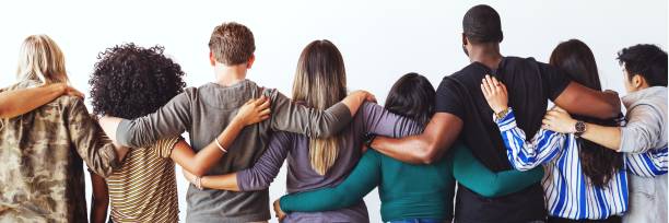 istock Diverse group of people standing together, arms linked. 2181647178
