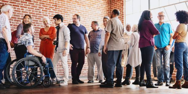 Diverse group of people socializing indoors.