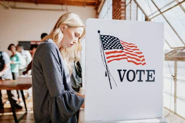 A woman voting at a polling station.