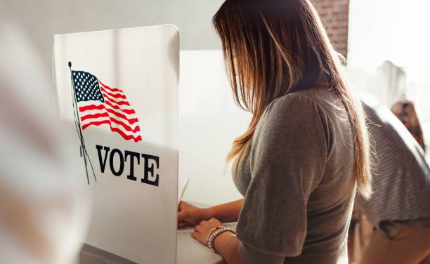 istock Woman voting at polling station. 2181648383