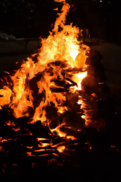 istock Fire flames on black background, Blaze fire flame texture background, Beautifully, the fire is burning, Fire flames with wood and cow dung bonfire 2181649384