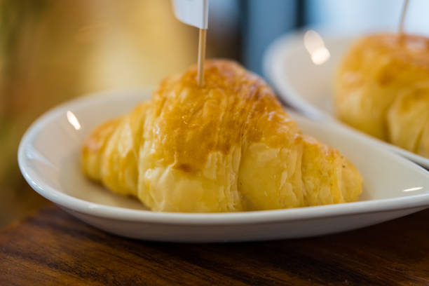 Freshly baked croissants served on white dish
