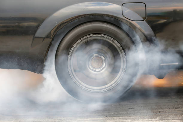 istock Drag racing car is burning tires at start line. 2181651712