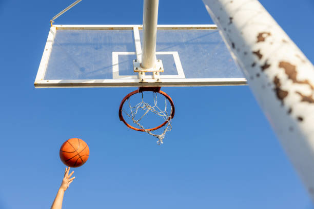 istock the basketball going into the hoop 2181655373