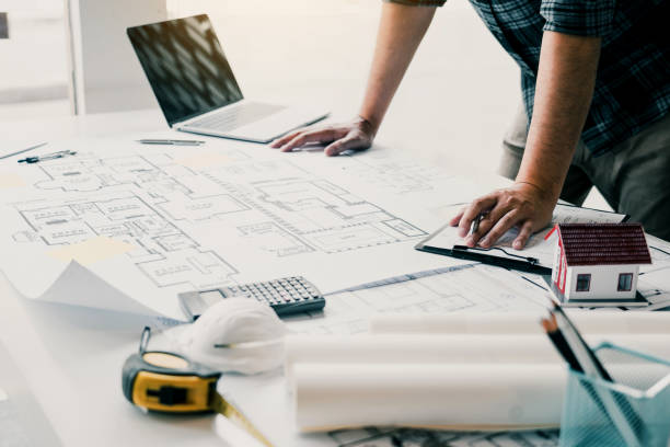 istock Engineers are designing working on blueprints and analyzing the structure of the project. 2181656610