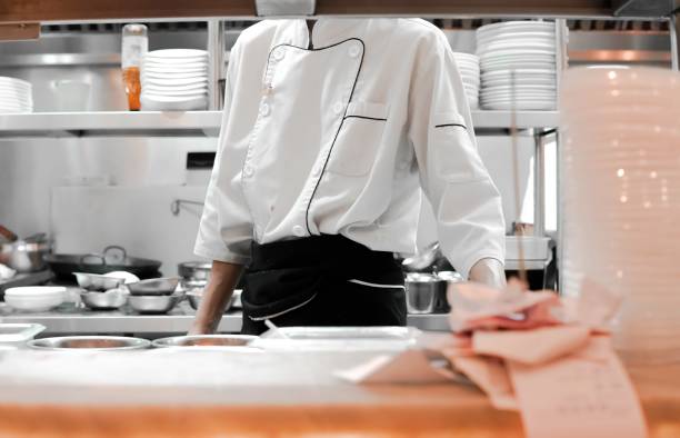 istock Restaurant Busy Kitchen, Chefs and Cooks Working on their Dishes 2181657303
