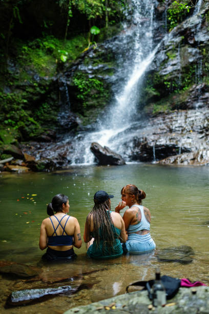 istock Three women sitting in a river to stay cool 2181659702