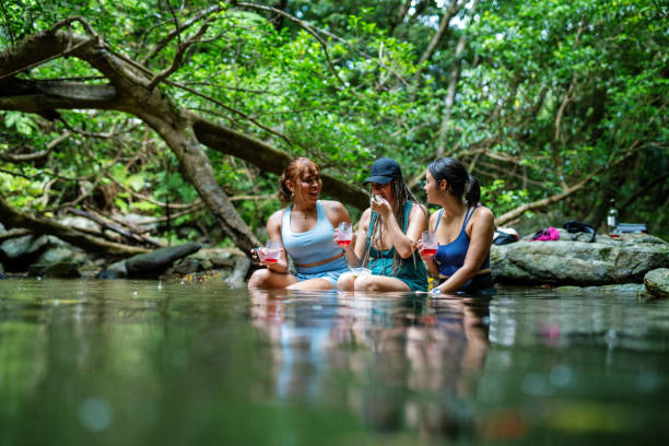 istock Three women sitting in a river to stay cool 2181659707