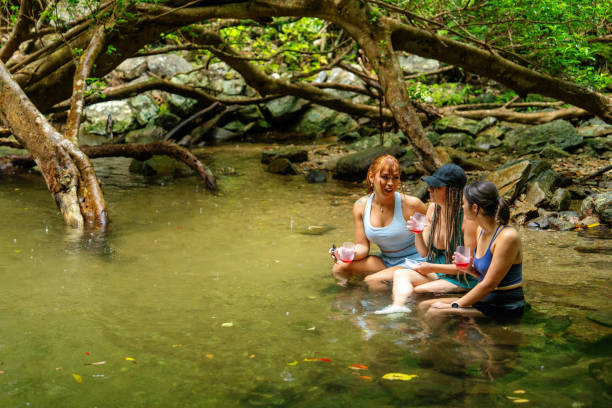 istock Three women sitting in a river to stay cool 2181659760