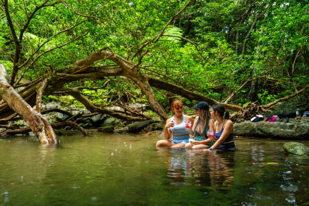 istock Three women sitting in a river to stay cool 2181659766