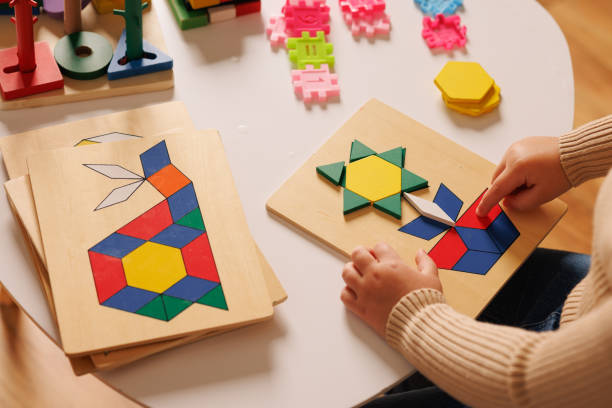 istock Close-up of children's hands playing with an educational multi-colored puzzle toy 2181660730