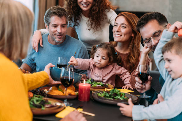 istock Happy extended family celebrating Thanksgiving at dining table. 2181662981