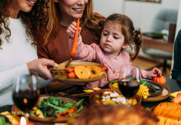 istock Happy extended family celebrating Thanksgiving at dining table. 2181662983