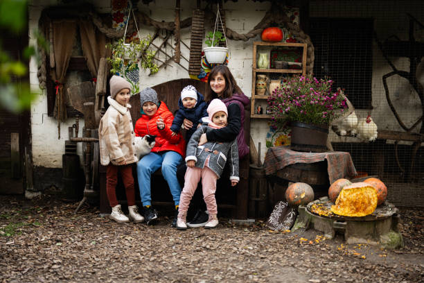 Family enjoying autumn day at rustic farmhouse setting
