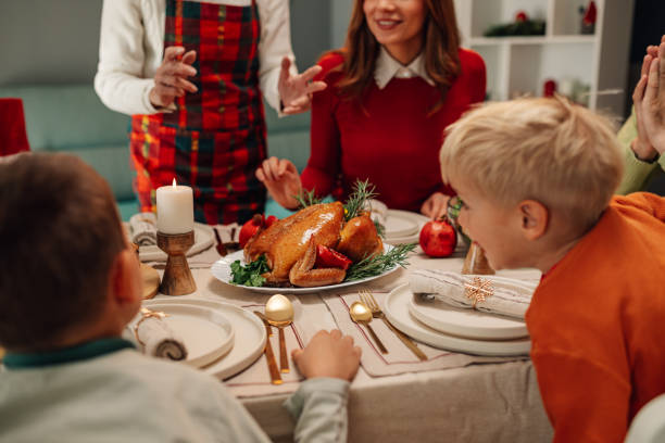 istock Family enjoying christmas dinner with roasted chicken as main course 2181664714