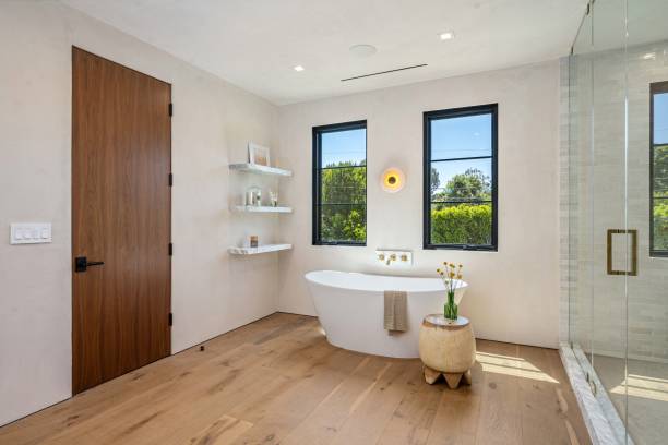 istock Modern bathroom with freestanding tub and large windows. 2181669206