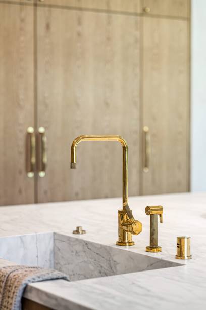istock Elegant kitchen sink with gold faucet. 2181669235
