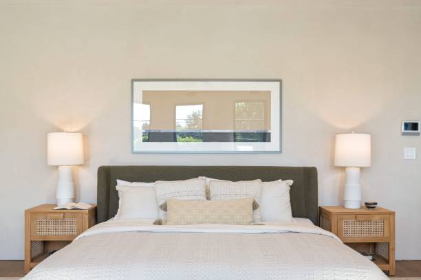 istock Modern bedroom interior with a neatly made bed and lamps. 2181669240