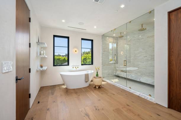 Modern bathroom with freestanding tub and glass shower.