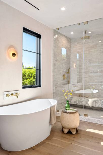 istock Modern bathroom with freestanding tub and glass shower. 2181671717