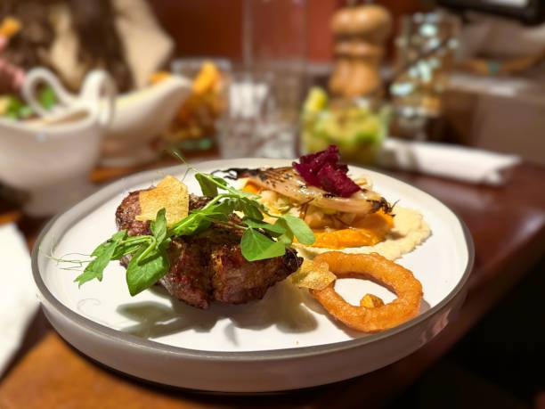 istock Juicy tenderloin served with a crispy onion ring and fresh salad 2181672580
