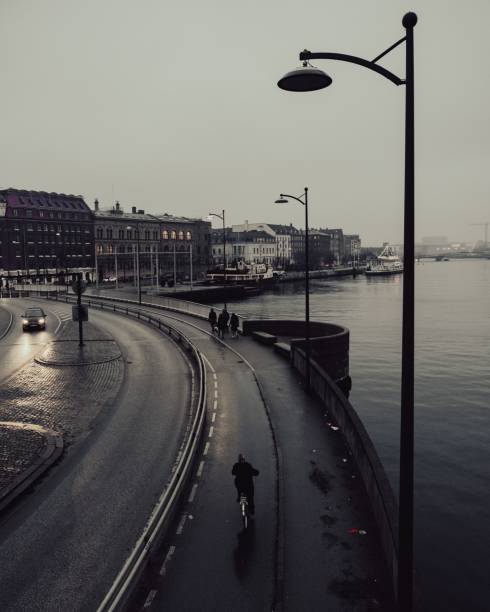 Cloudy day in Copenhagen, Denmark, people on the street, person riding a bike