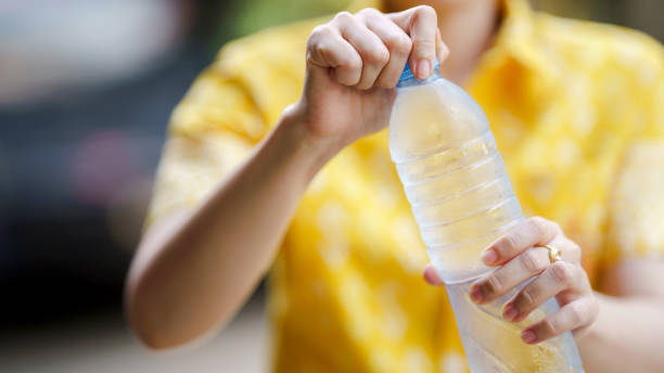 istock Opening water bottle with refreshing touch on sunny day 2181680918