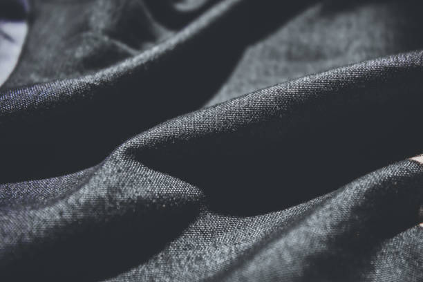 istock dark black fabric background close up.  beautiful fabric in dark ash 2181682242