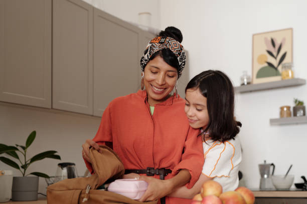 Mother and Daughter Packing Lunch Together