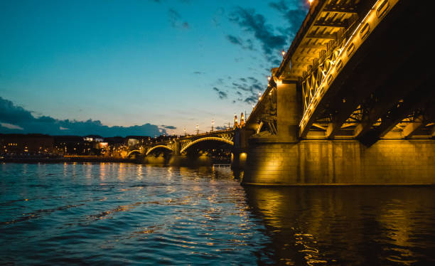 Evening lights on the bridge on the river Danube in Budapest during sunset. The Danube is the second longest river in Europe and flows between Buda and Pest in Hungary