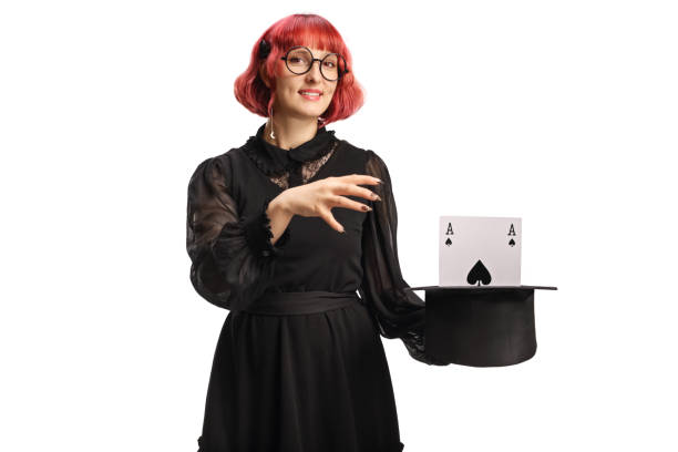 Female magician with a top hat performing a magic trick with an ace isolated on white background