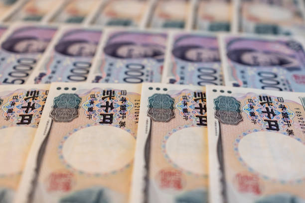Japanese yen bills completely covering the frame, creating a textured background of financial notes, highlighting the precision and vibrancy of the currency design