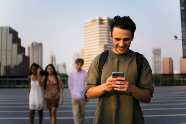 istock Happy male college student texting on phone walking in campus 2181688918