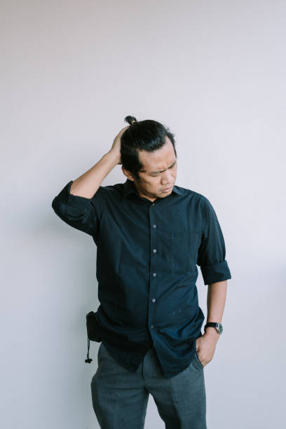 istock Southeast Asian man holding his head with both hands 2181689382
