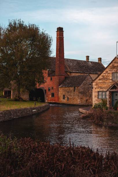 istock Historic stone mill by a tranquil river in the Cotswolds. 2181691183