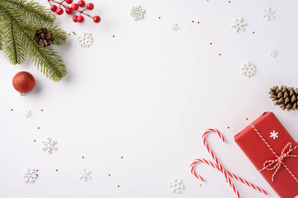 istock A festive Christmas scene featuring a neatly arranged collection of holiday elements including a present, pine cones, candy canes, and snowflakes, evoking a sense of warmth and celebration 2181692417