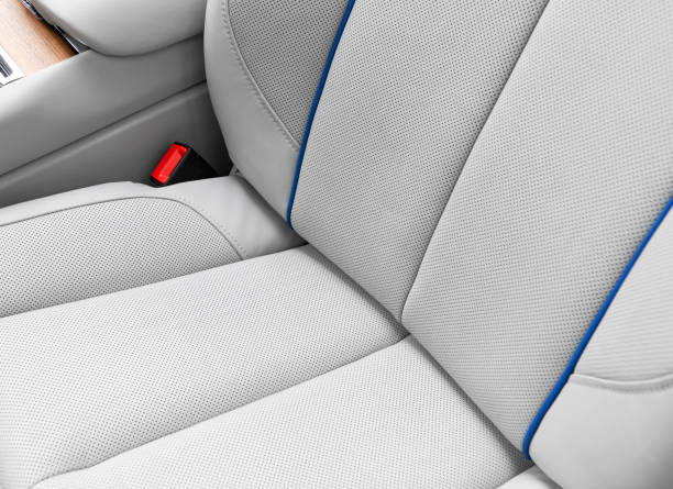 istock White leather interior of the luxury modern car. Perforated white leather comfortable seats with stitching.  Modern car interior details. Car inside 2181693650