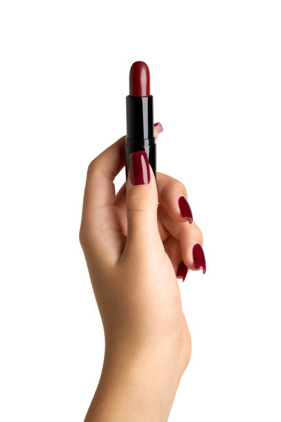istock The hand with red manicure holds red lipstick, isolated on white background 2181693948