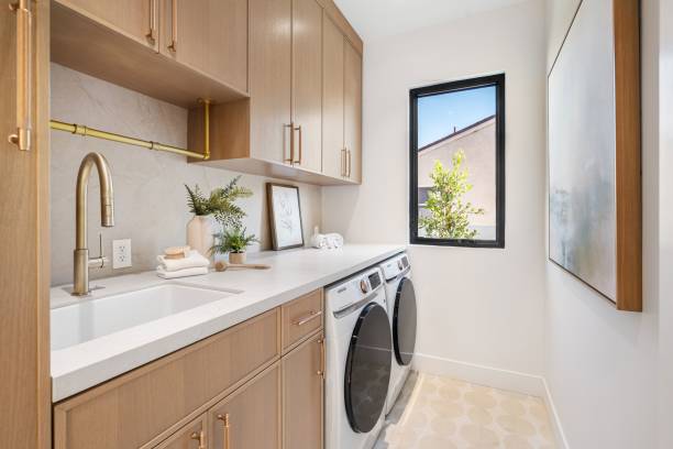Modern laundry room with wooden cabinets and appliances.