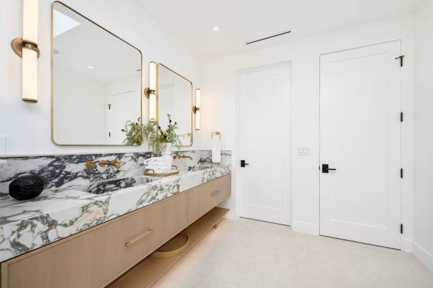 istock Modern bathroom with marble countertop and dual sinks. 2181694052
