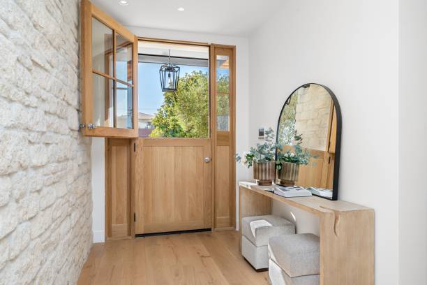 istock Modern entryway with wooden door and decor. 2181694064