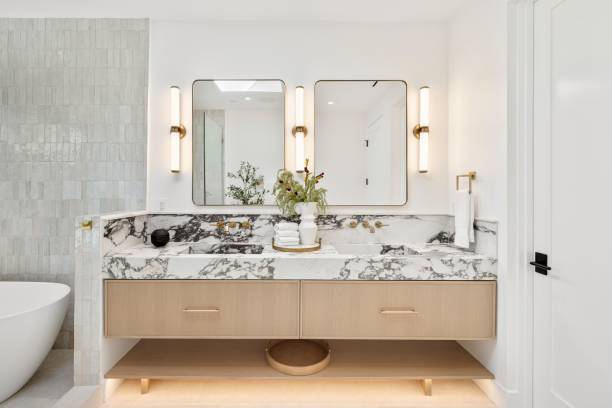 istock Modern bathroom with marble countertop and dual mirrors. 2181694077