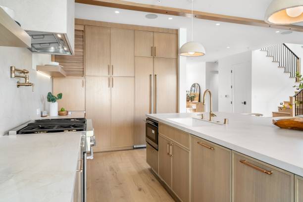 istock Modern kitchen with wooden cabinets and marble countertops. 2181694109