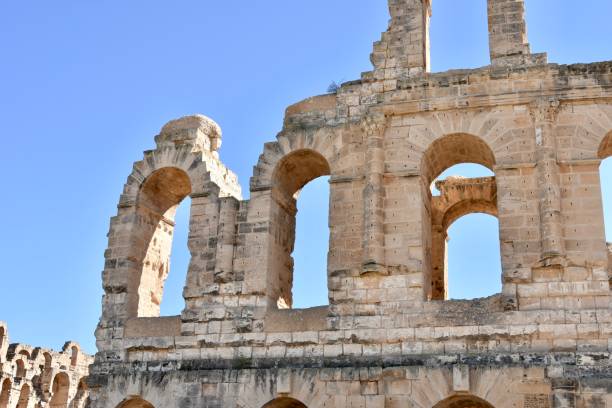 istock Ruined Roman Amphitheater Outer Wall with Tall Arches and Clear Blue Sky 2181695143