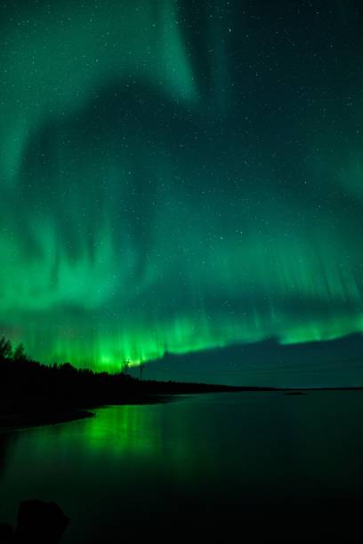 istock Northern Lights over a tranquil lake 2181695300