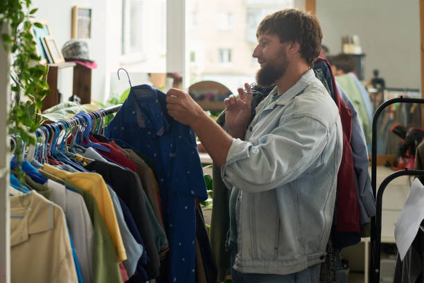 istock Taking hanger with blue shirt from rack 2181696525