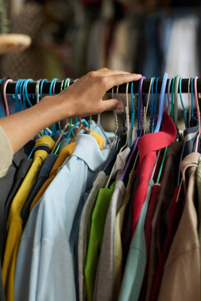 istock Hand of customer on rack with attire 2181696555